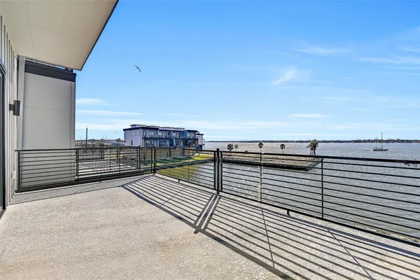 a view of a balcony with wooden floor and city view