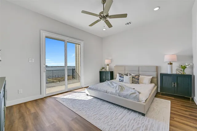 a bedroom with a large bed and a chandelier