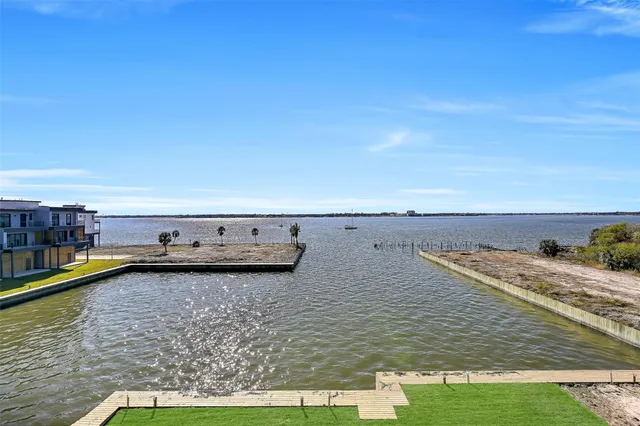 a front view of a house with swimming pool and a big yard