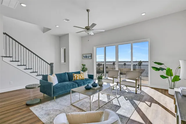a living room with furniture potted plant and a ceiling fan