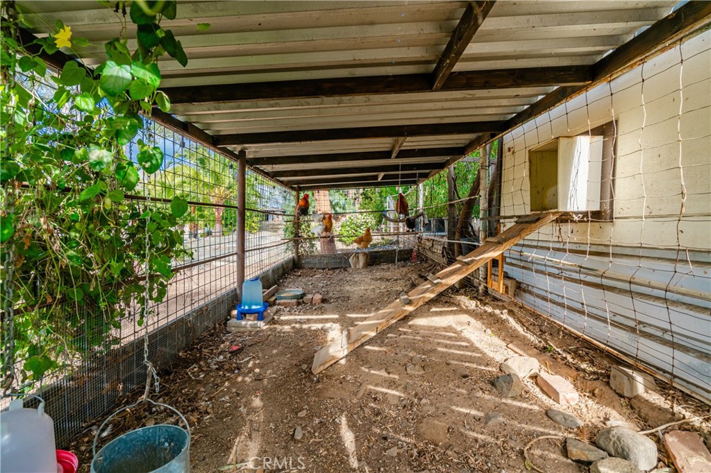 20950 Claire Road Perris, CA 92570 - Photo 13 of 74 a view of a backyard with chairs and a wooden fence