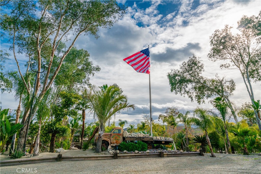20950 Claire Road Perris, CA 92570 - Photo 25 of 74 a front view of a house with a yard and potted plants