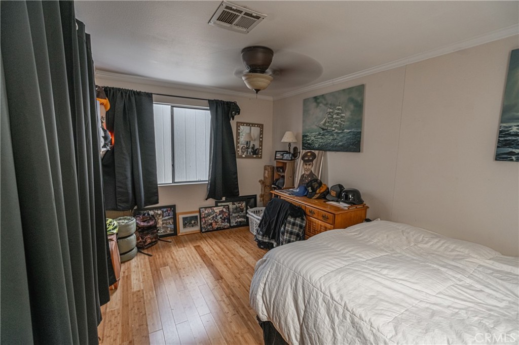 20950 Claire Road Perris, CA 92570 - Photo 38 of 74 a bedroom with bed a mirror and desk