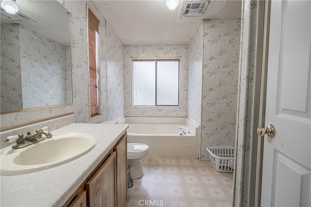 20950 Claire Road Perris, CA 92570 - Photo 48 of 74 a bathroom with a sink toilet and shower