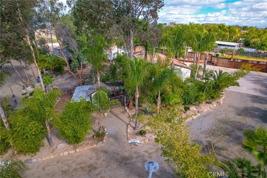 20950 Claire Road Perris, CA 92570 - Photo 55 of 74 a view of a garden with lawn chairs under an umbrella