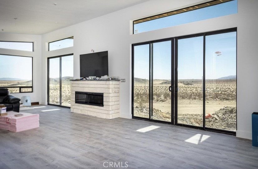 20950 Claire Road Perris, CA 92570 - Photo 74 of 74 a view of an empty room with furniture a fireplace and wooden floor