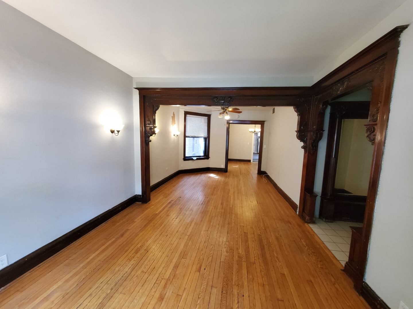 665 West Roscoe Street, Unit 1 Chicago, IL 60657 - Photo 2 of 10 wooden floor in an empty room with a window