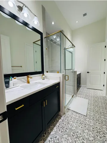 a bathroom with a double vanity sink and a mirror