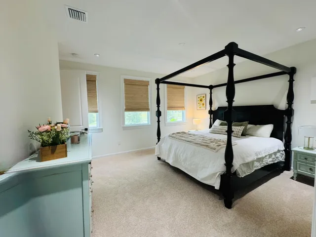 a bedroom with a bed and a potted plant