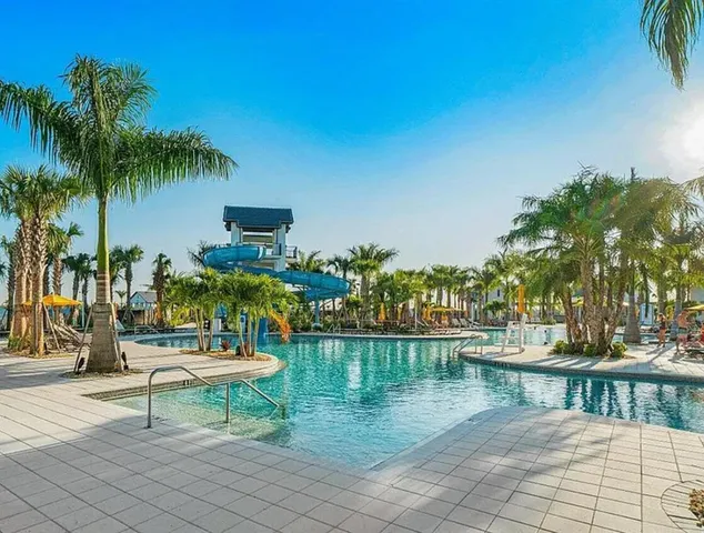 a view of a lake with a bench and trees