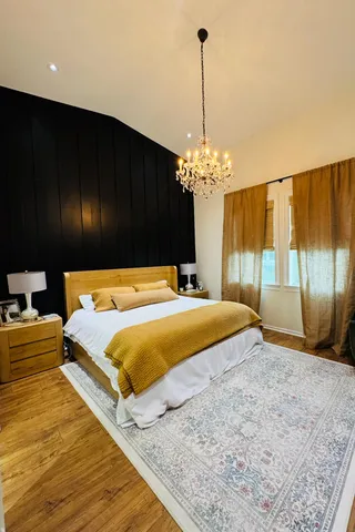 a bedroom with a bed and chandelier