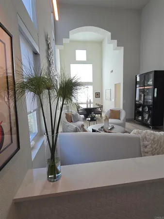 a living room with furniture or chandelier and a wooden floor