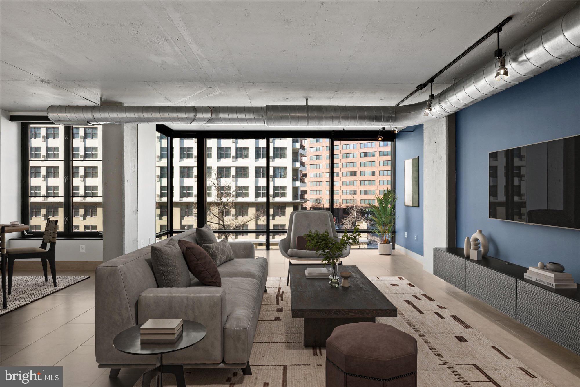 1133 14th Street Northwest, Unit 404 Washington, DC 20005 - Photo 5 of 15 a living room with furniture large windows and wooden floor