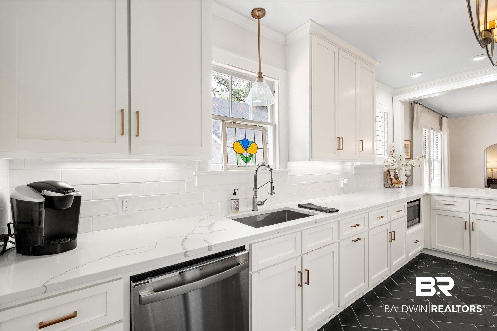 112 Crenshaw Street Mobile, AL 36606 - Photo 10 of 21 Kitchen featuring light stone countertops, tasteful backsplash, white cabinets, appliances with stainless steel finishes, and a sink