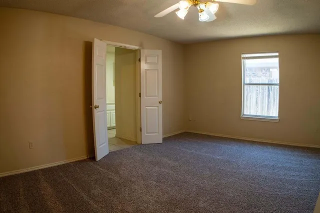 an empty room with windows and closet