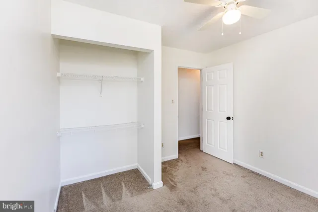 a view of an empty room with closet
