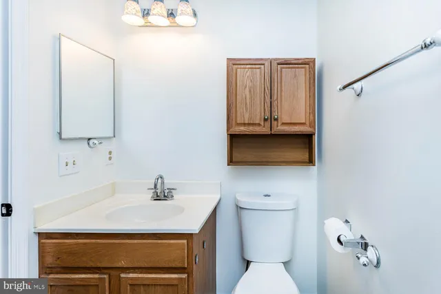 a bathroom with a sink a toilet and mirror