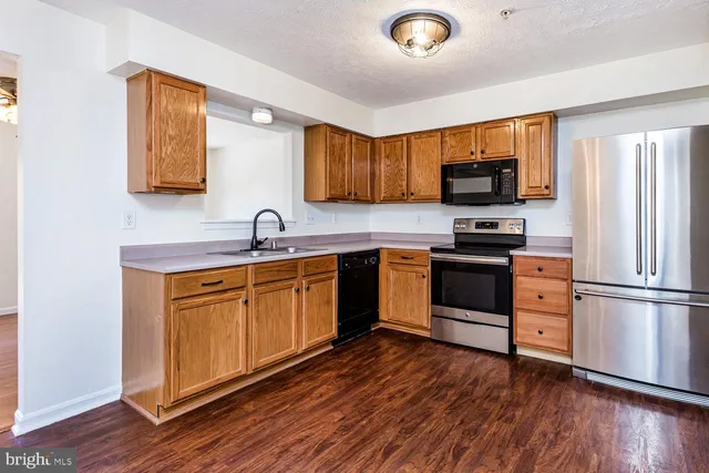 a kitchen with a refrigerator stove and sink