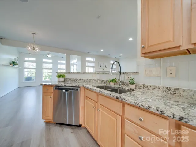 a kitchen with stainless steel appliances granite countertop wooden cabinets and a granite counter tops