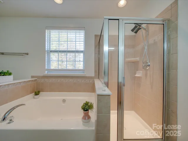 a bathroom with a bathtub and a shower