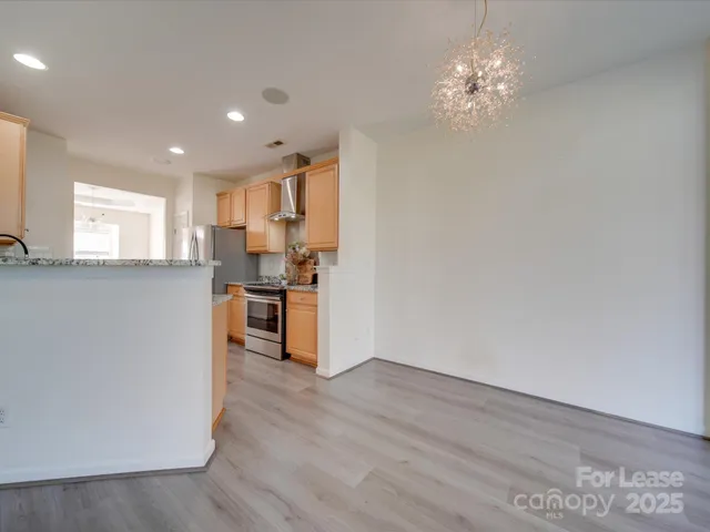 a kitchen with cabinets and wooden floor