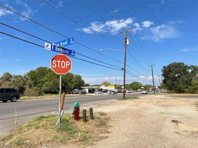 a view of a street with benches