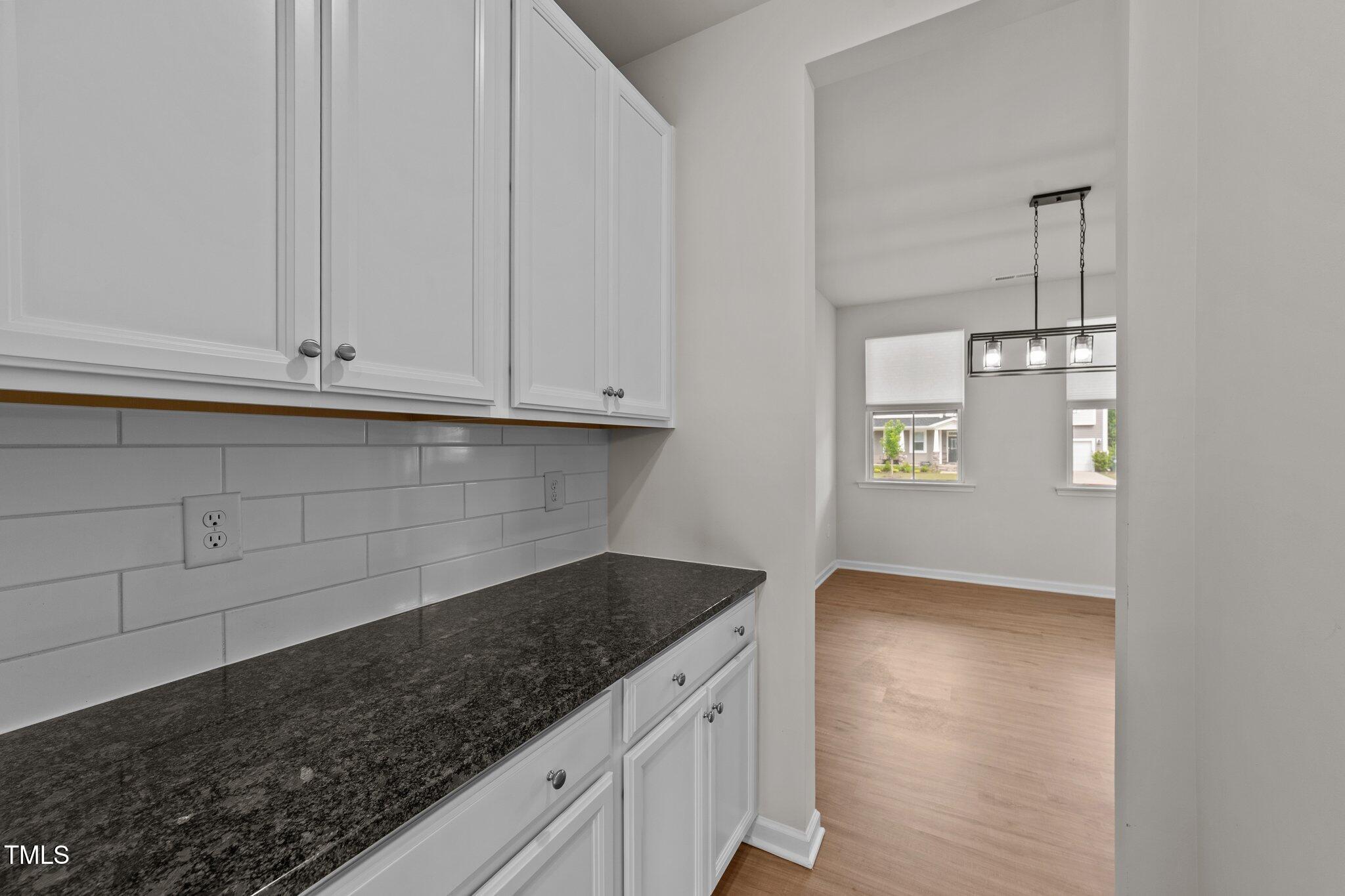 188 Karlov Road Garner, NC 27529 - Photo 11 of 38 a kitchen with granite countertop white cabinets and a stove