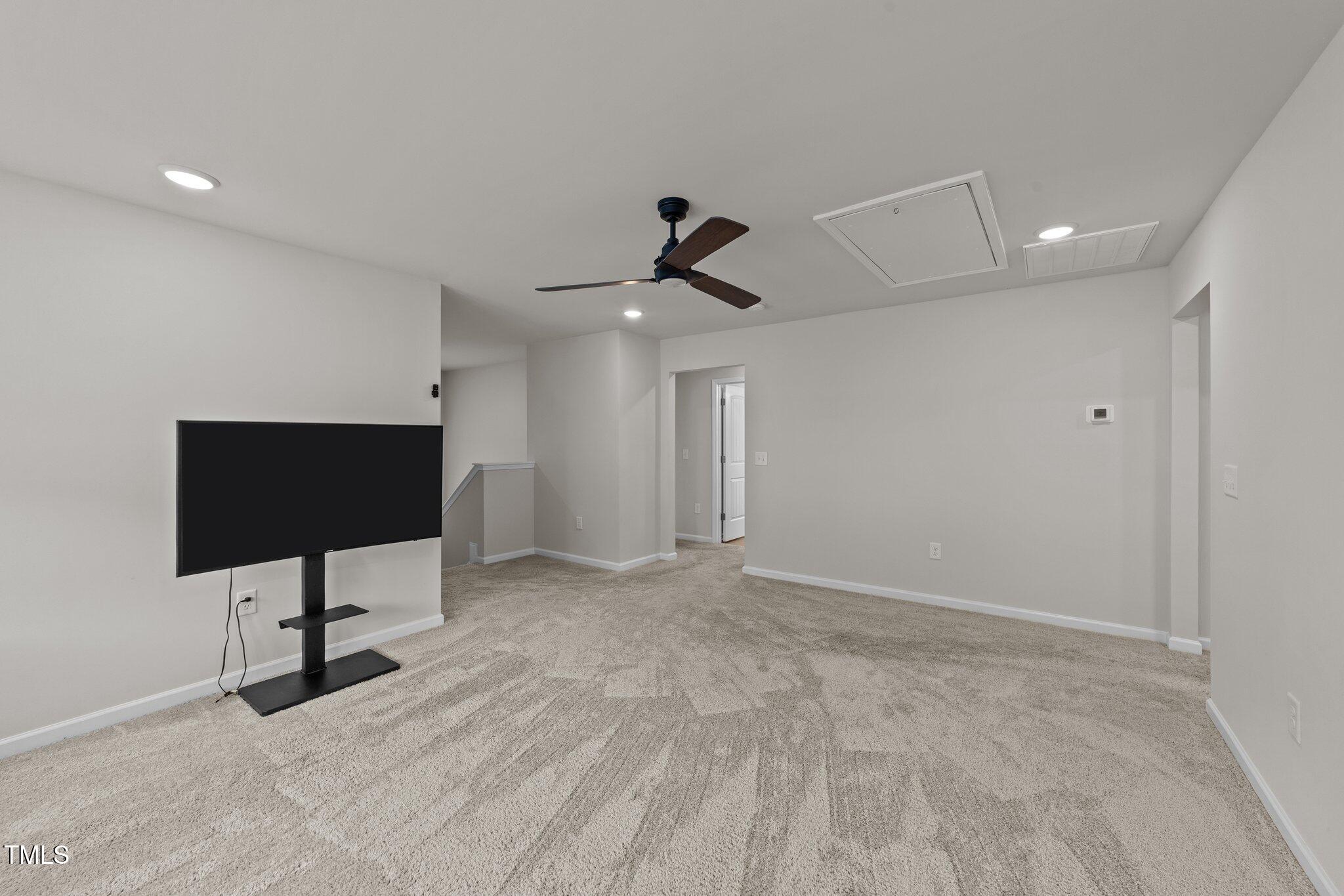188 Karlov Road Garner, NC 27529 - Photo 19 of 38 a view of an empty room with a ceiling fan