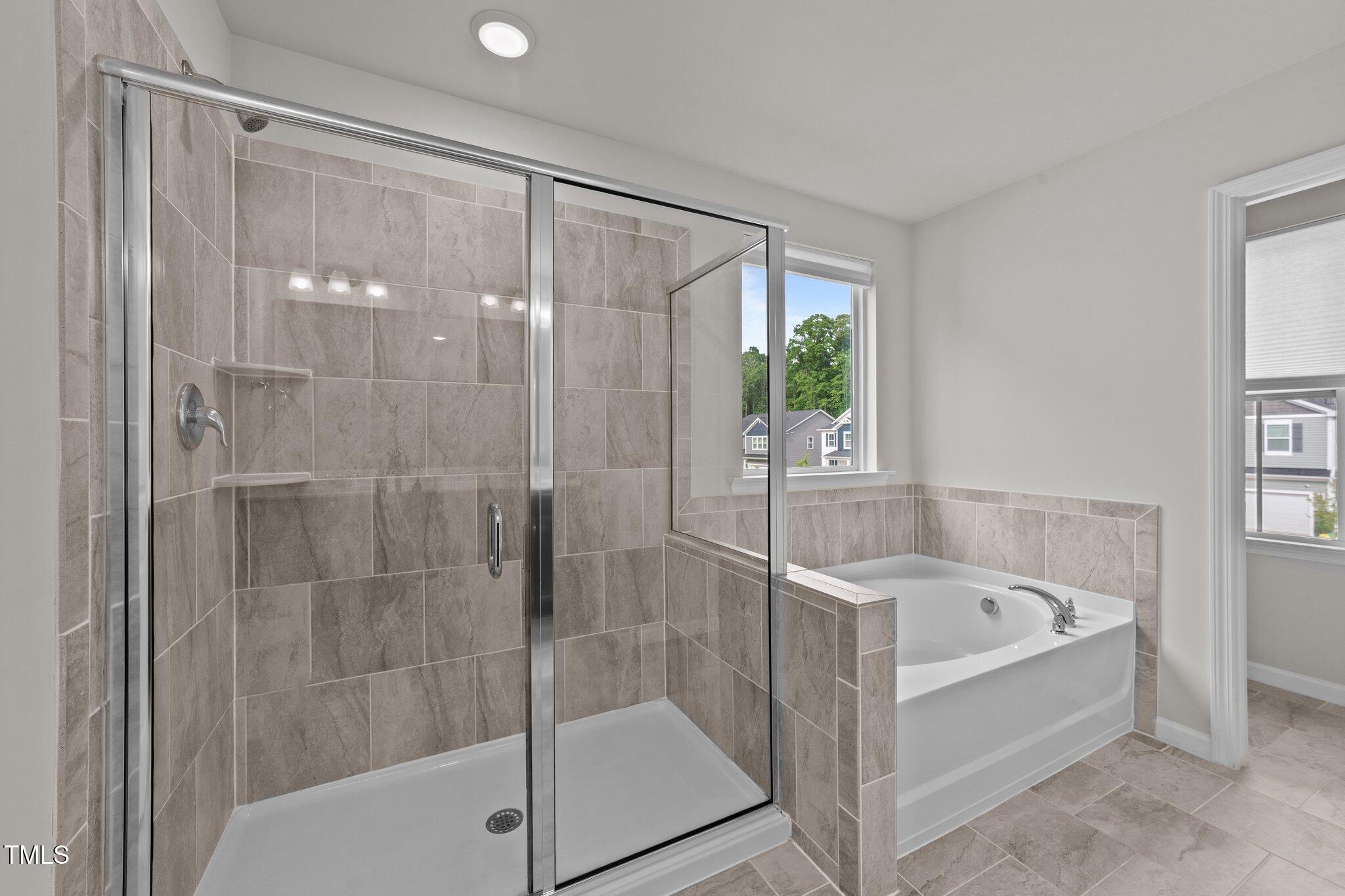 188 Karlov Road Garner, NC 27529 - Photo 23 of 38 a bathroom with a bathtub and a shower