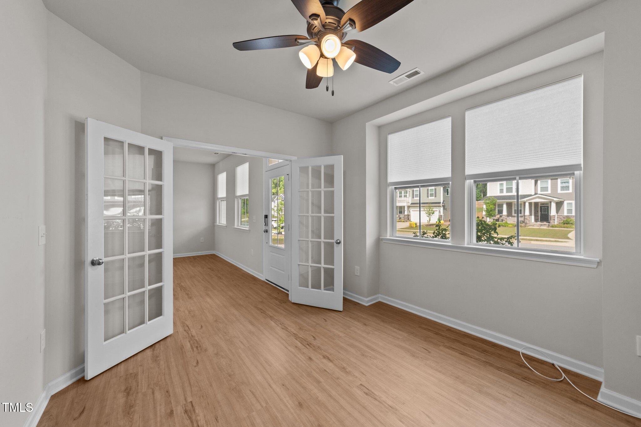 188 Karlov Road Garner, NC 27529 - Photo 4 of 38 a view of an empty room with window and wooden floor