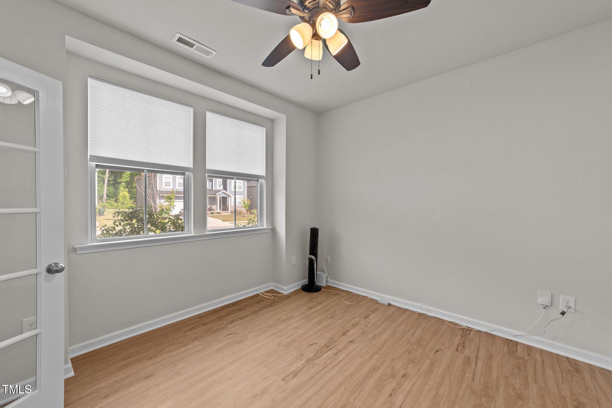 188 Karlov Road Garner, NC 27529 - Photo 5 of 38 a view of empty room with wooden floor and fan