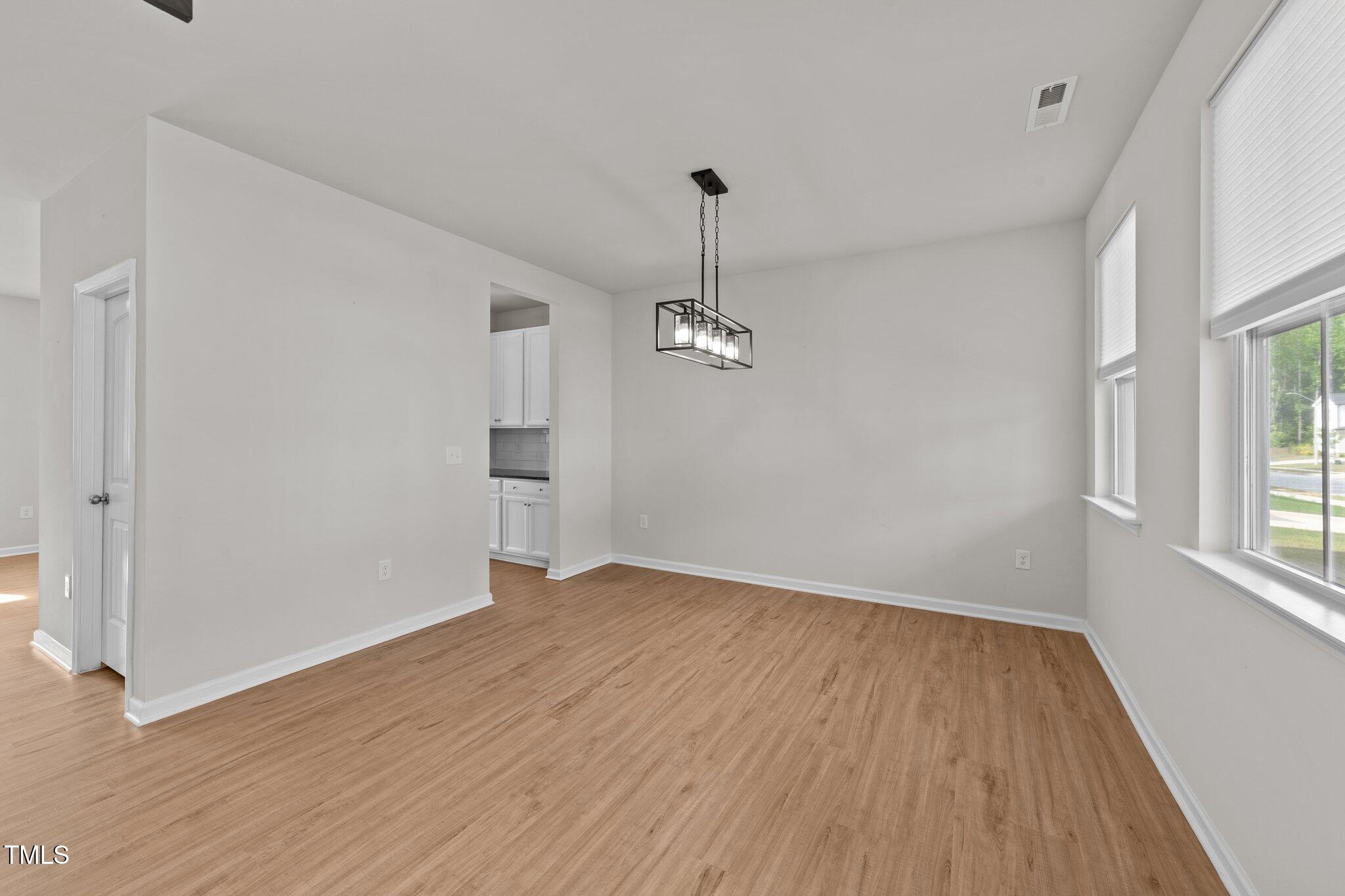 188 Karlov Road Garner, NC 27529 - Photo 6 of 38 wooden floor in an empty room with a window