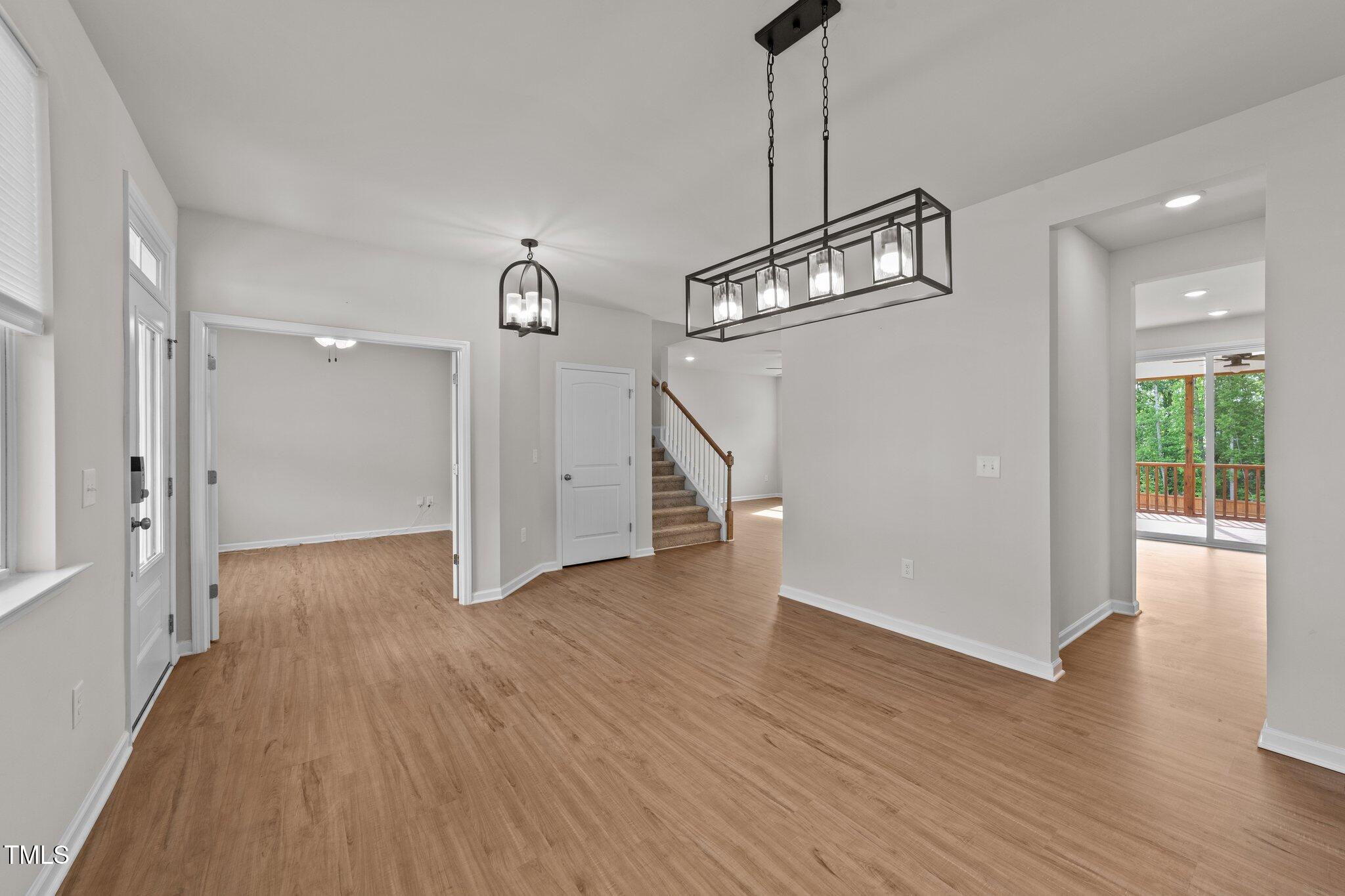 188 Karlov Road Garner, NC 27529 - Photo 7 of 38 a view of a hallway with wooden floor and staircase