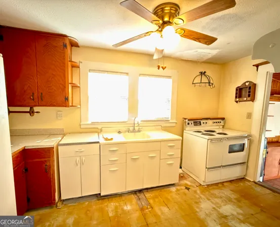 a kitchen with a stove a sink and a refrigerator