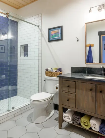 a bathroom with a toilet a sink and shower