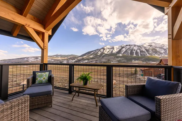 an outdoor view from a balcony with seating space