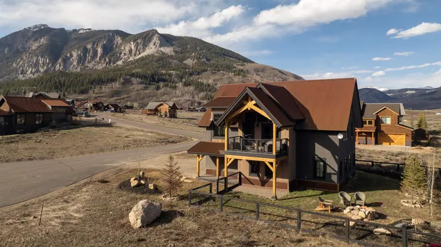 a view of a house with a yard and covered in snow