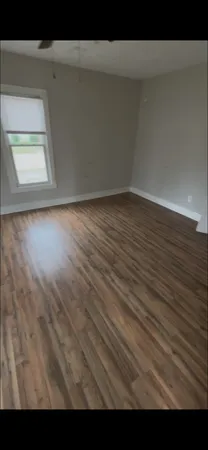 a view of wooden floor and windows in a room