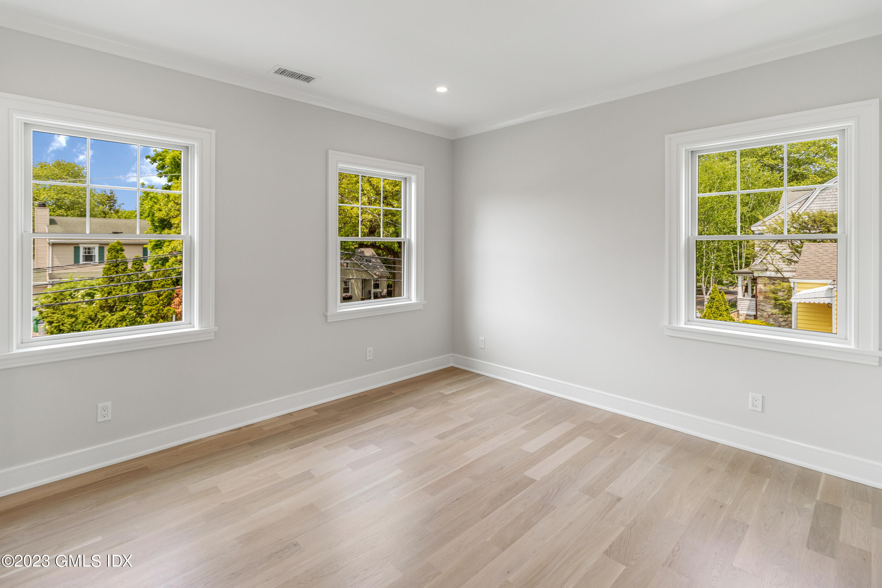10 Sunshine Avenue Riverside, CT 06878 - Photo 16 of 27 a view of an empty room with a window and wooden floor