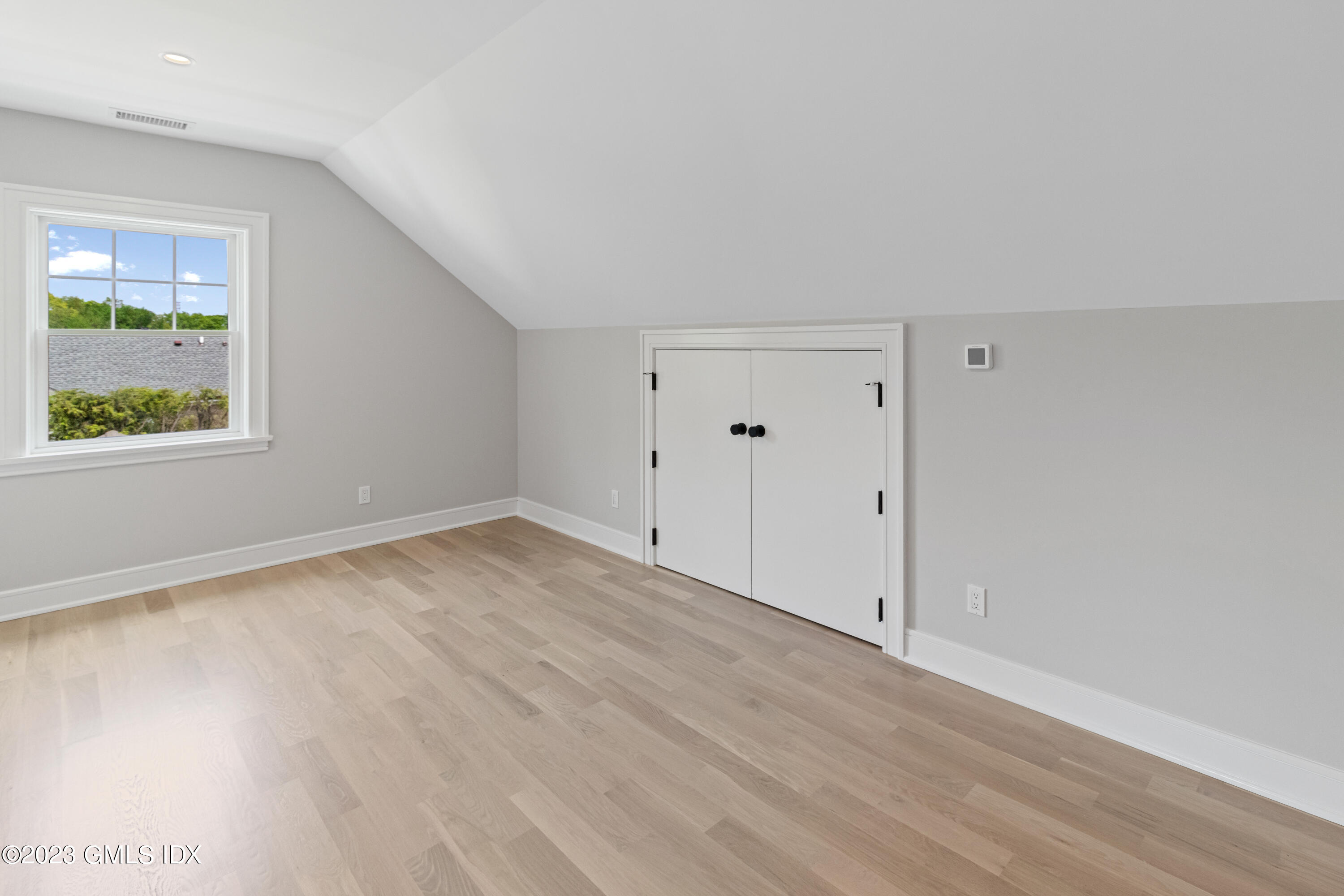 10 Sunshine Avenue Riverside, CT 06878 - Photo 19 of 27 an empty room with wooden floor and window