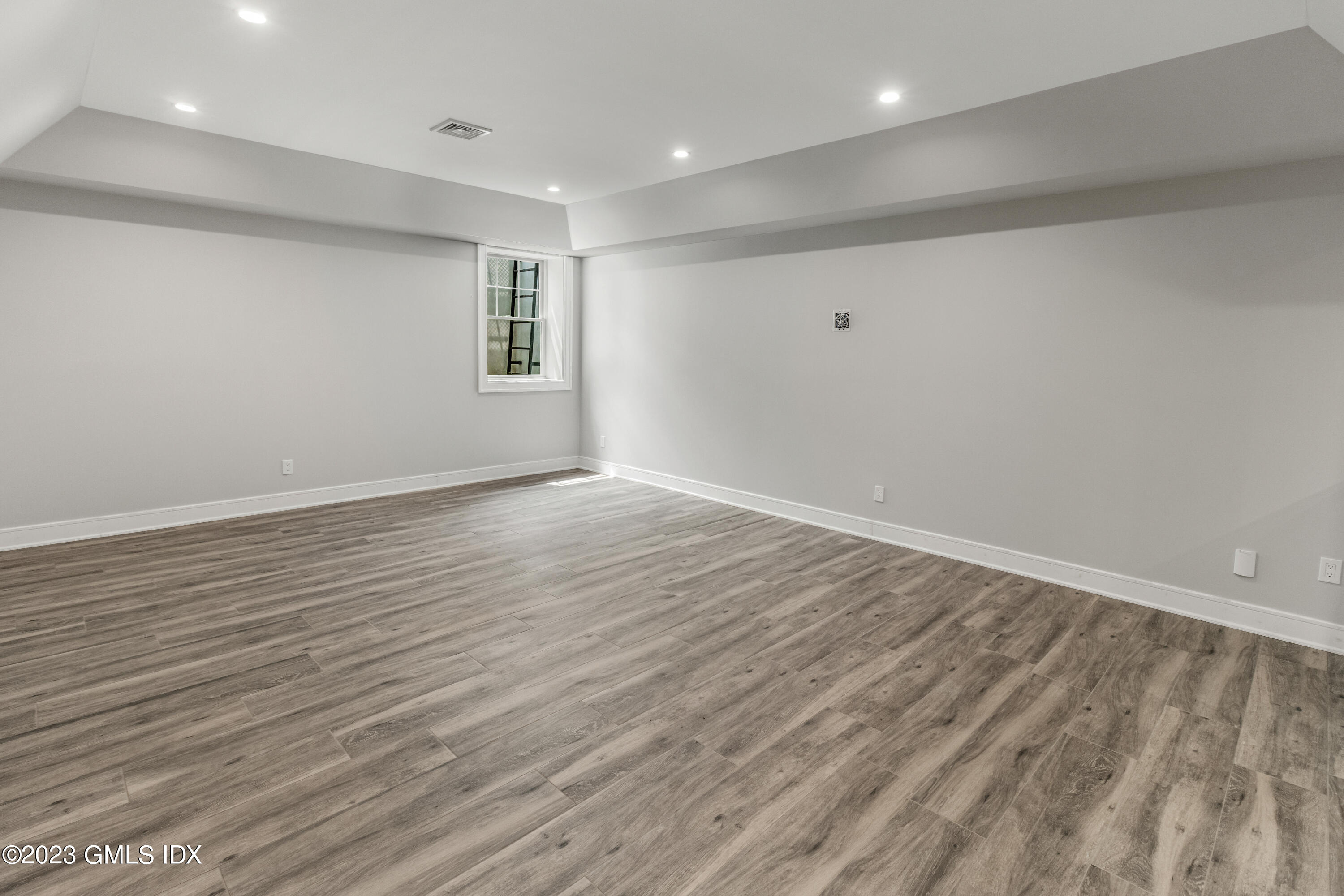 10 Sunshine Avenue Riverside, CT 06878 - Photo 21 of 27 a view of an empty room with wooden floor