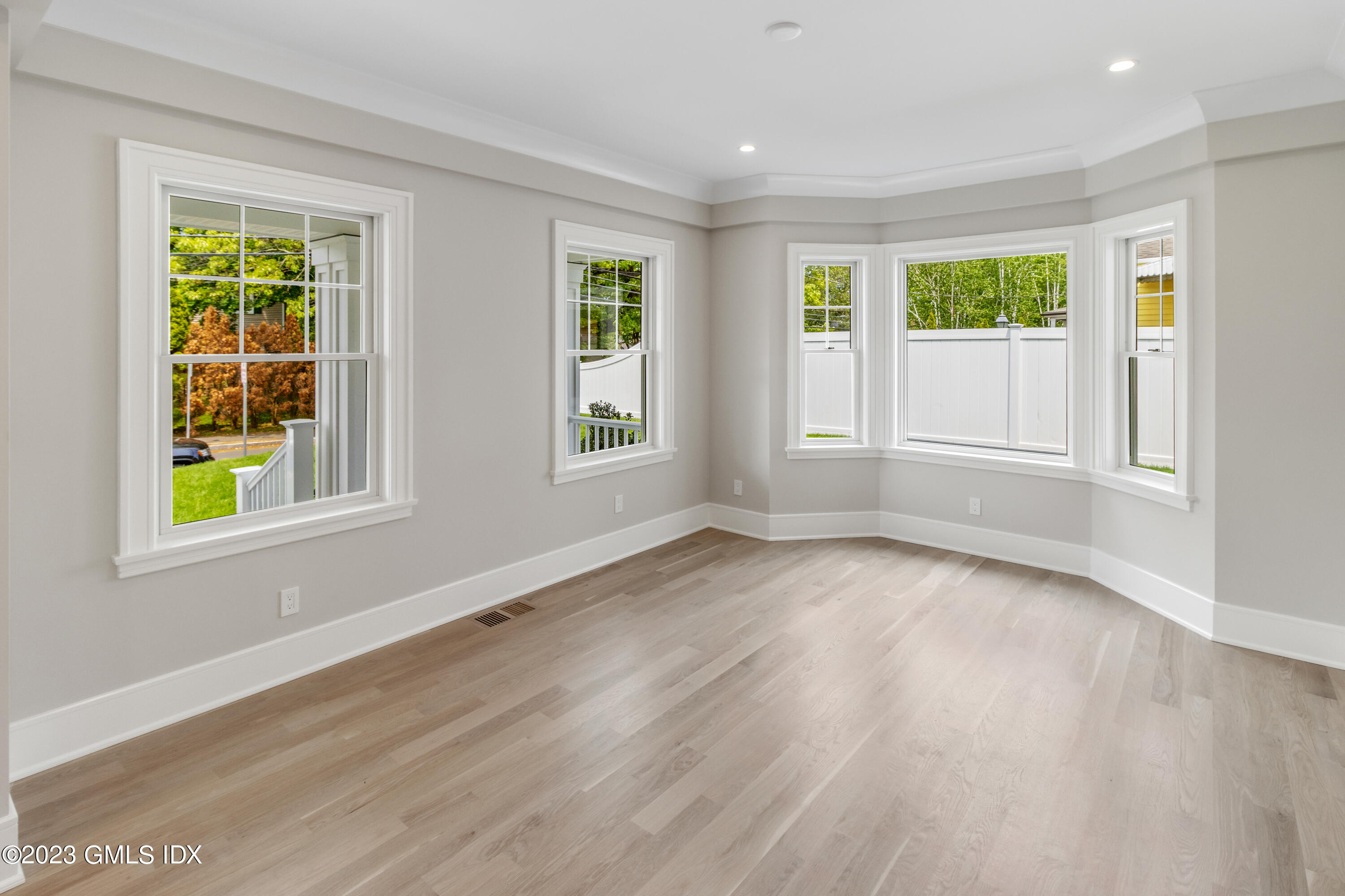 10 Sunshine Avenue Riverside, CT 06878 - Photo 5 of 27 an empty room with wooden floor and windows