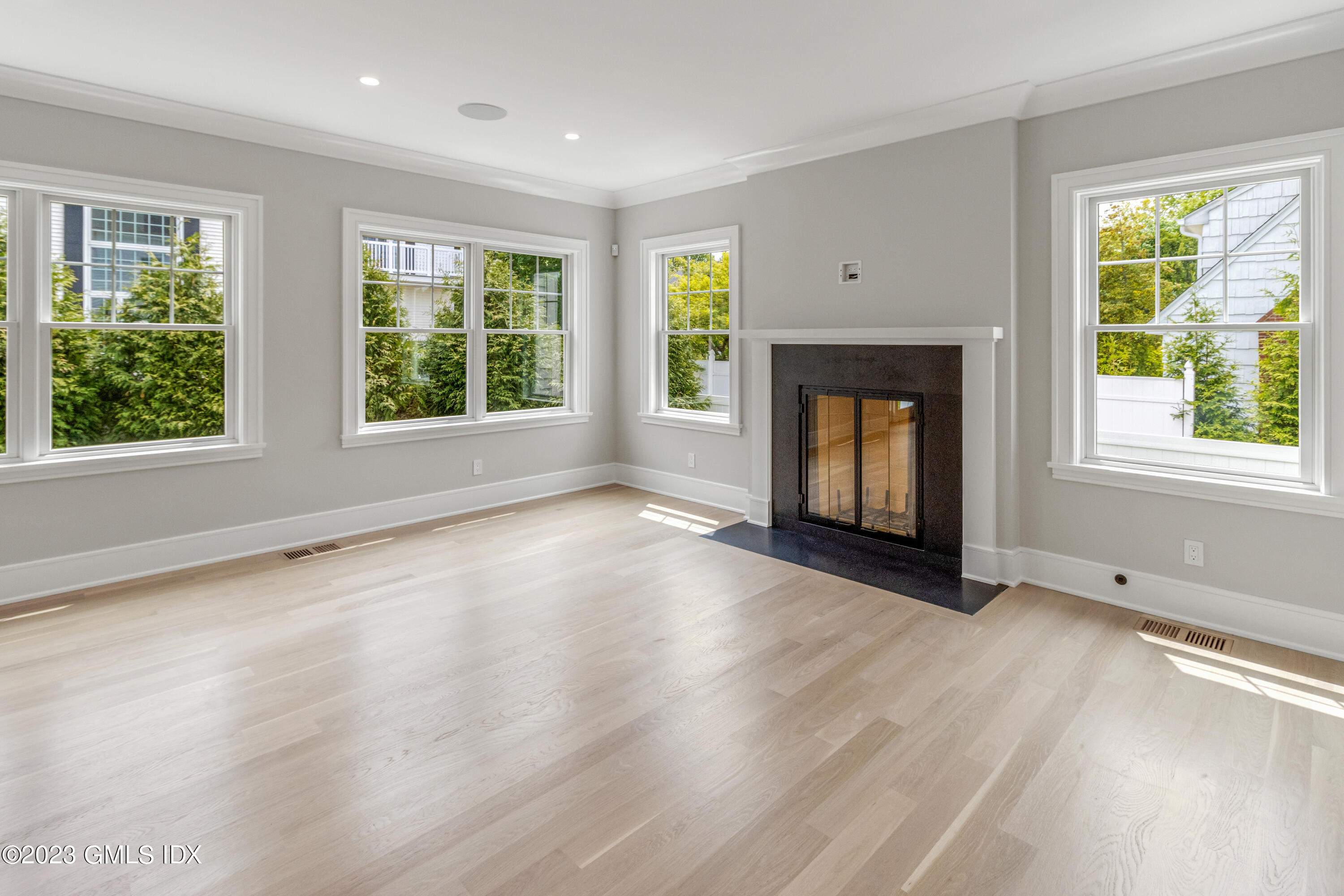 10 Sunshine Avenue Riverside, CT 06878 - Photo 7 of 27 an empty room with windows and fireplace