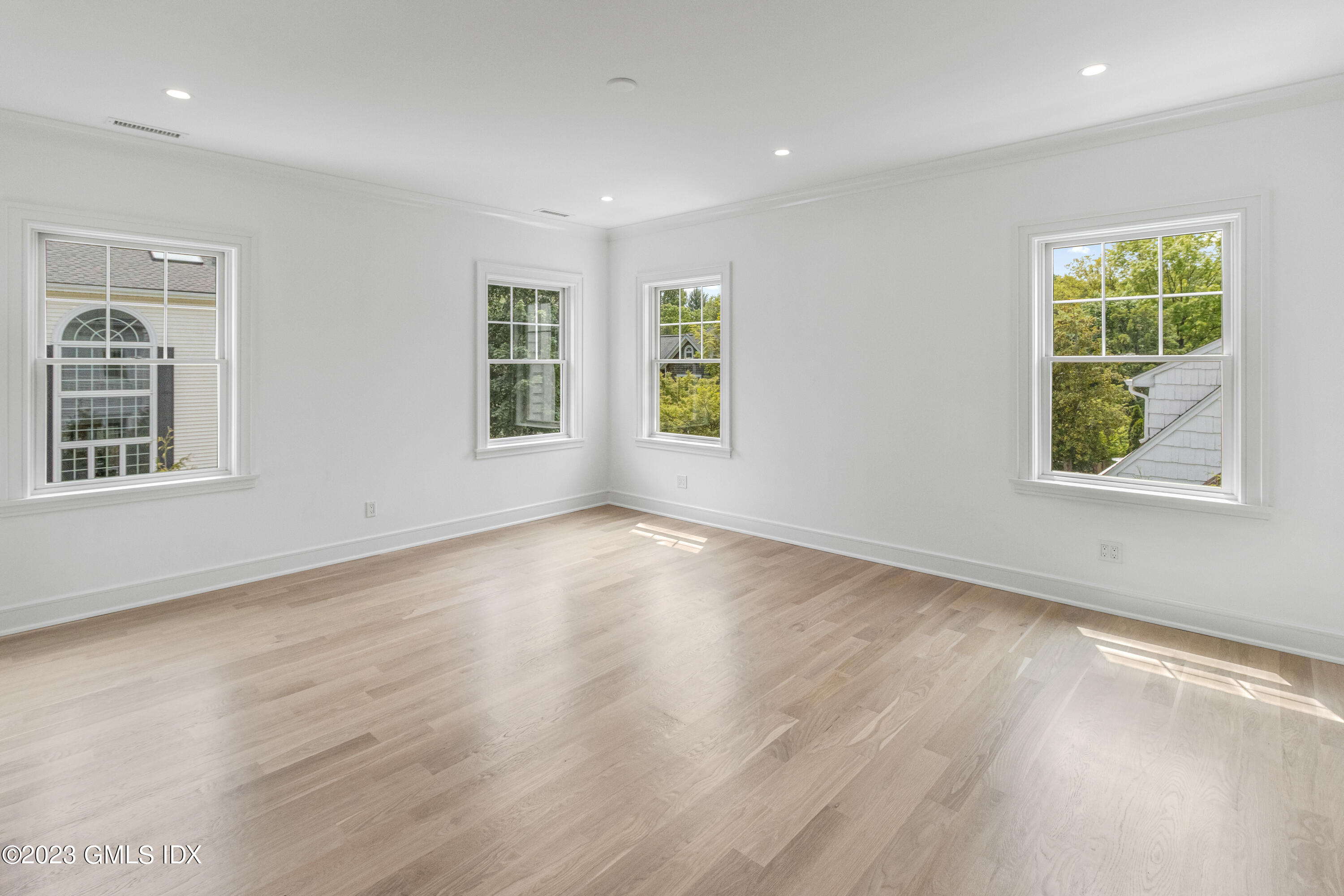 10 Sunshine Avenue Riverside, CT 06878 - Photo 9 of 27 an empty room with wooden floor and windows