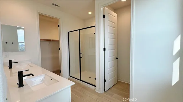a bathroom with a shower sink and mirror