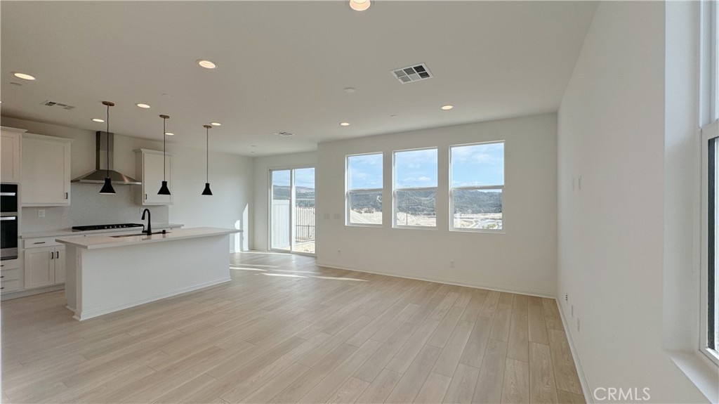 751 Cornelia Way Rancho Mission Viejo, CA 92694 - Photo 3 of 15 a large kitchen with a large counter top a sink stainless steel appliances and cabinets