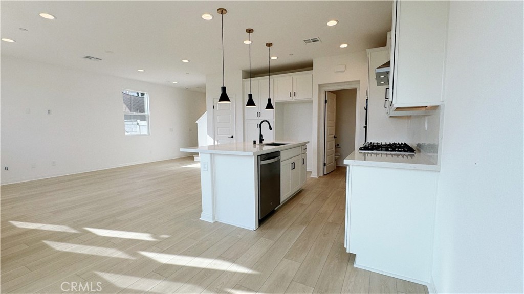 751 Cornelia Way Rancho Mission Viejo, CA 92694 - Photo 4 of 15 a kitchen with stainless steel appliances granite countertop a refrigerator and a stove top oven
