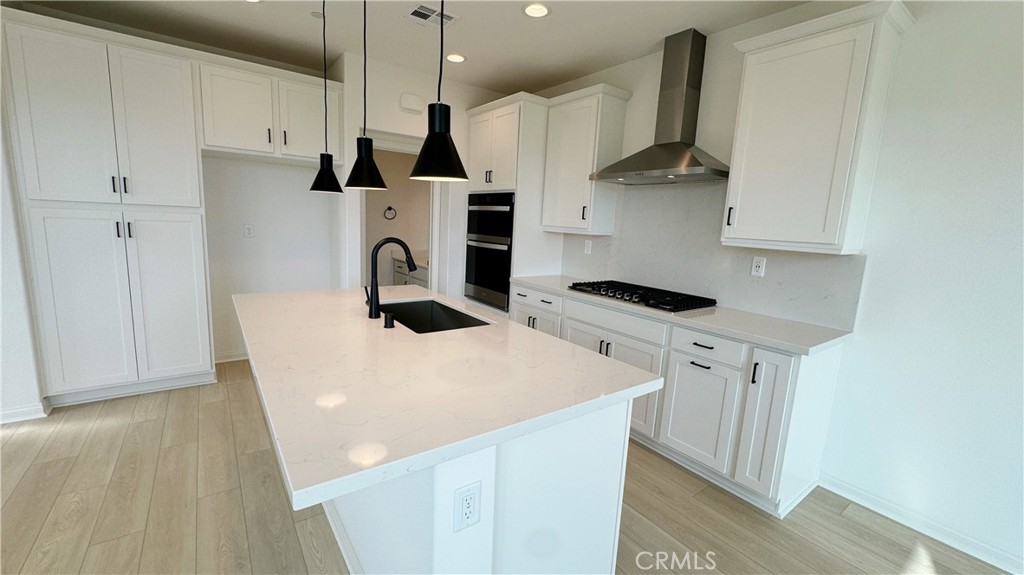 751 Cornelia Way Rancho Mission Viejo, CA 92694 - Photo 5 of 15 a kitchen with stainless steel appliances a stove a sink a refrigerator a counter space and cabinets