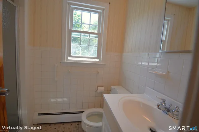a white toilet sitting next to a bathroom sink