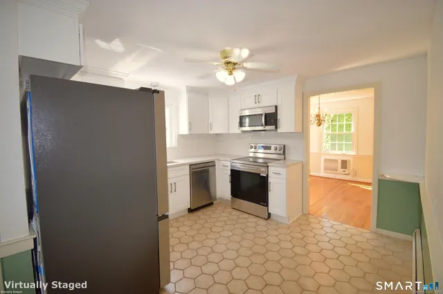 a kitchen with a stove a sink and a refrigerator